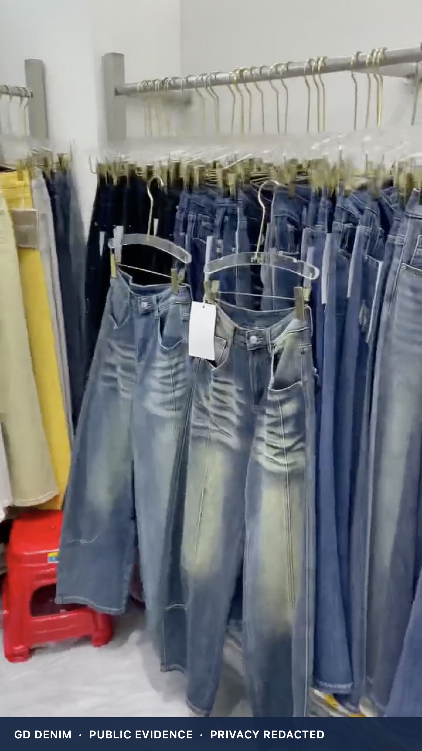 Original close view of women’s jeans displayed on rails inside Guangzhou wholesale booth A117