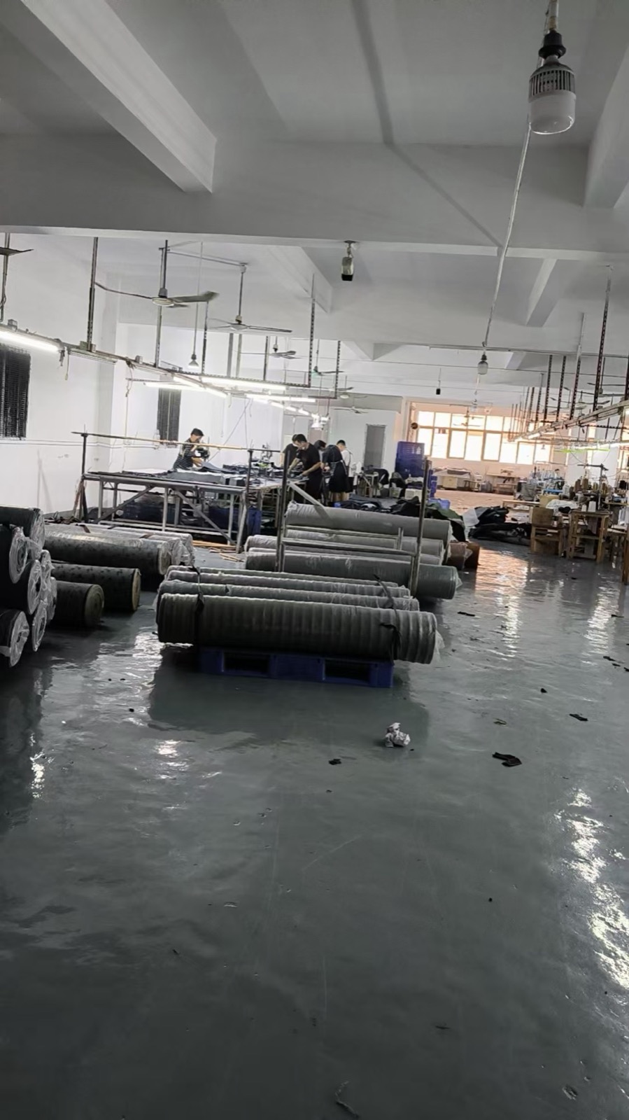 Denim fabric rolls organised inside the Guangzhou workshop