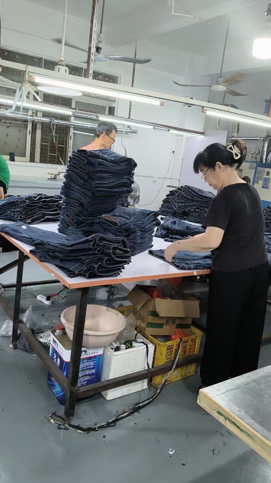 Completed women’s jeans being sorted and prepared for packing