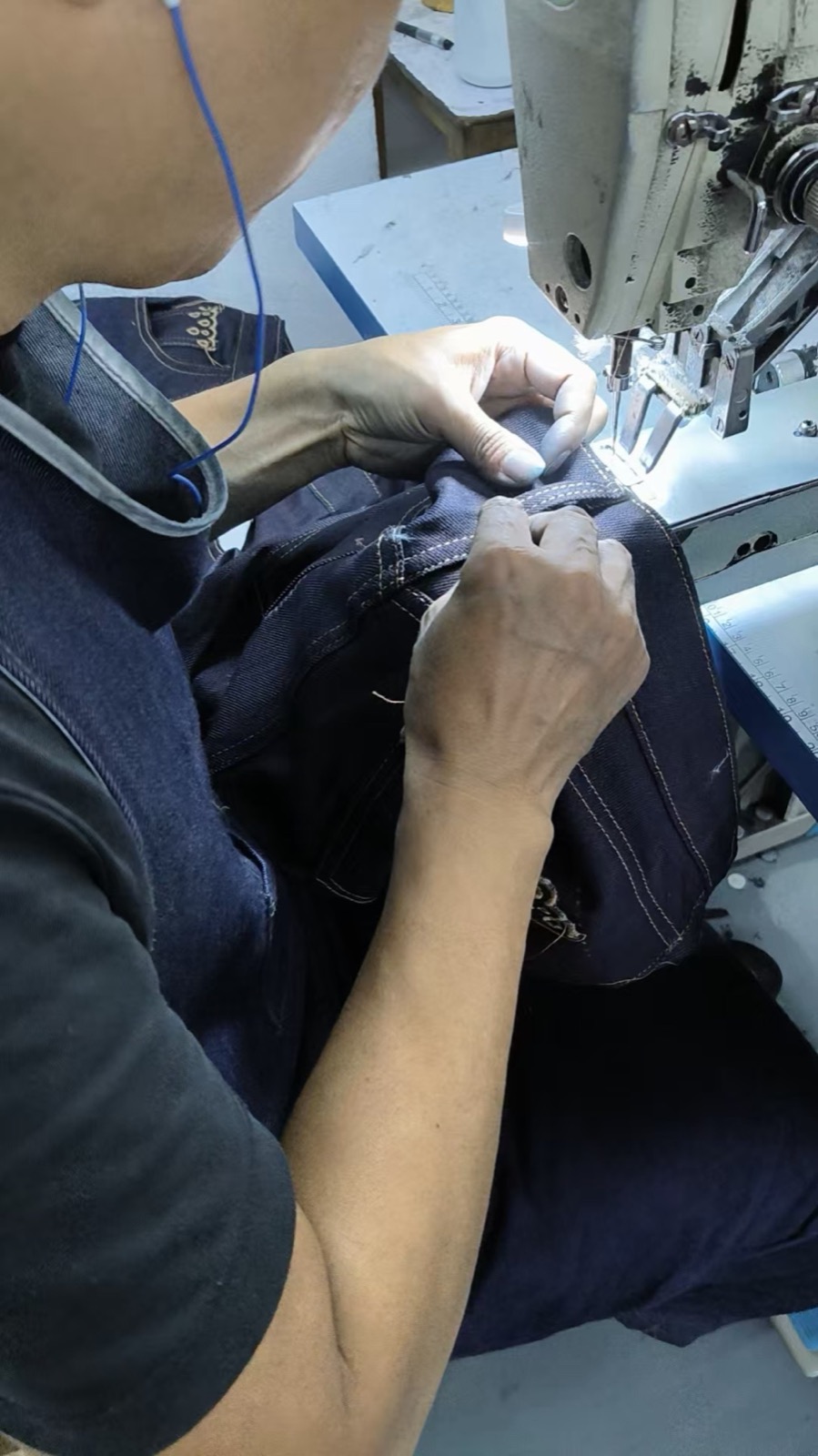 Close view of precision stitching on a pair of women’s jeans